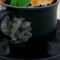 This shows the back of the cup with the the lace decoupage covering the crack. It is a nice contrast with the midnight blue.